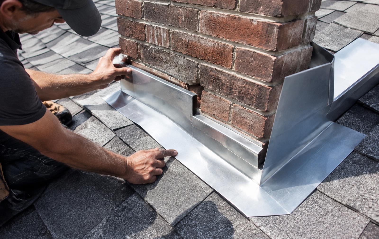 New metal flashing around a brick chimney