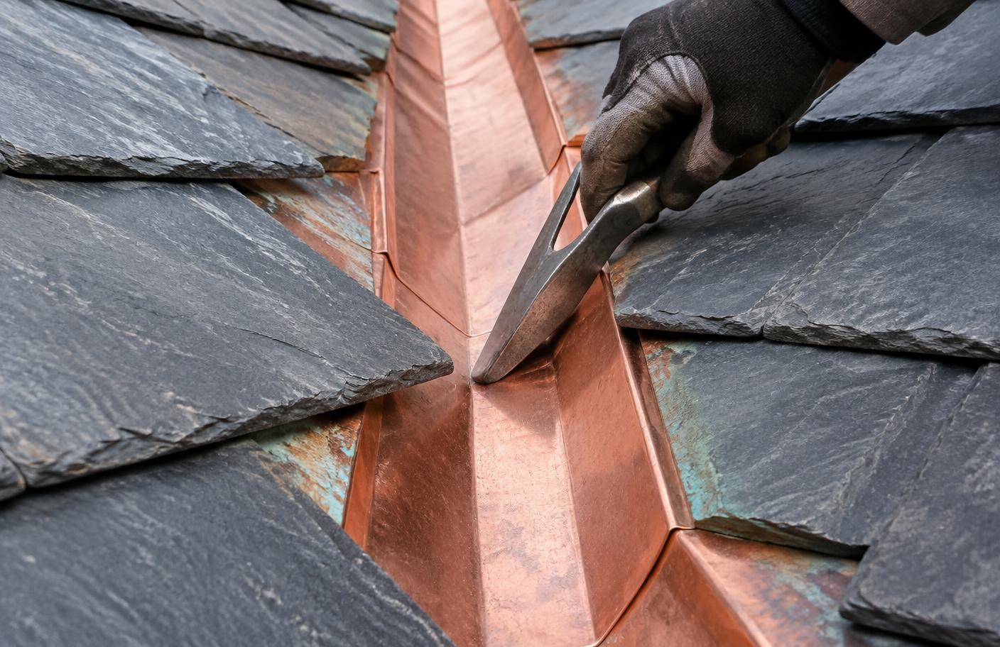 Hand-finished copper valley between natural slate roof slopes